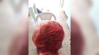 Redhead talks to her husband while sucking her lover's cock