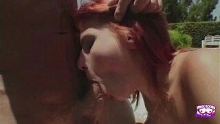 A saucy redhead gets her pussy eaten by the pool and gives a footjob