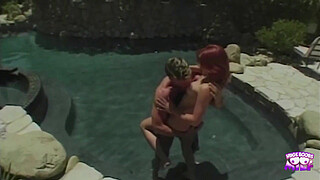 A saucy redhead gets her pussy eaten by the pool and gives a footjob