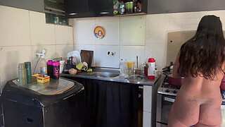 Young girl with a big butt washing dishes completely naked.