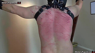 Hooded femdom slave is whipped and stomped by Tangent