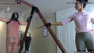 Hooded femdom slave is whipped and stomped by Tangent