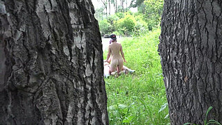 Voyeur outdoors peeps at two naked lesbians. Nudists with big asses sunbathe and enjoy nature and masturbation.