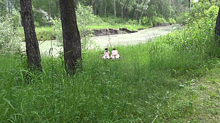 Voyeur outdoors peeps at two naked lesbians. Nudists with big asses sunbathe and enjoy nature and masturbation.