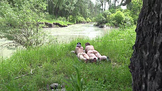 Voyeur outdoors peeps at two naked lesbians. Nudists with big asses sunbathe and enjoy nature and masturbation.