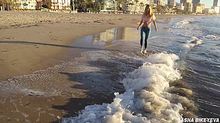Wet shoot on a public beach with Crazy Model. Risky outdoor masturbation. Foot fetish. Pee in jeans.