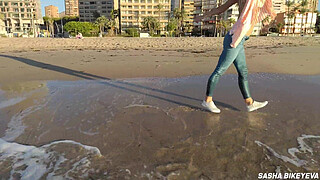 Wet shoot on a public beach with Crazy Model. Risky outdoor masturbation. Foot fetish. Pee in jeans.