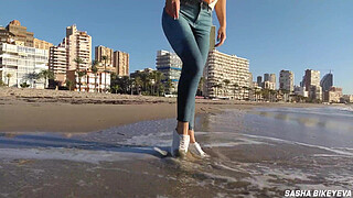 Wet shoot on a public beach with Crazy Model. Risky outdoor masturbation. Foot fetish. Pee in jeans.