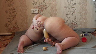 The girl masturbates her pussy with her fingers and various sex toys