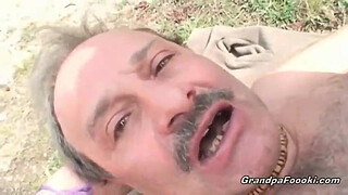 Superb babe rides grandpa's cock in nature