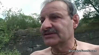Superb babe rides grandpa's cock in nature