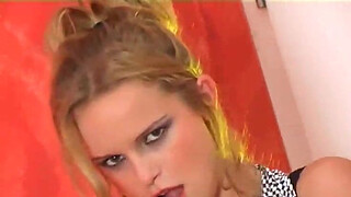 Blonde in black boots and stockings rubs her pussy