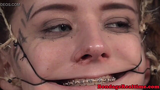 Femdom rubs pussyjuice on suspended teen