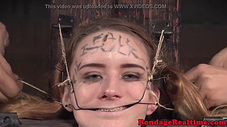 Femdom rubs pussyjuice on suspended teen