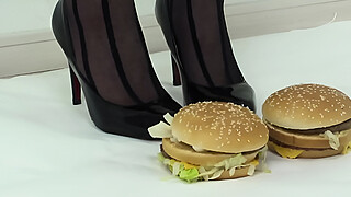 Foodcrush A woman steps on a hamburger with stockings