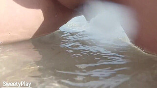 Shaved pussy peeing on public beach