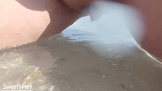 Shaved pussy peeing on public beach