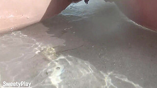 Shaved pussy peeing on public beach