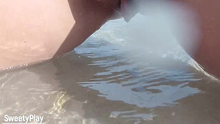 Shaved pussy peeing on public beach