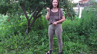 MILF pee in tight pants in a public park open air. Dirty cunt squatting pissing in the yard.