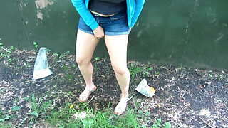Cunt pissed with a powerful stream behind public garages. Brunette loves to pee outdoors.