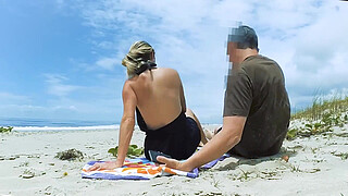 Filming an anal scene on the beach in front of passersby