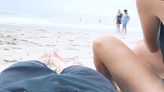 Filming an anal scene on the beach in front of passersby