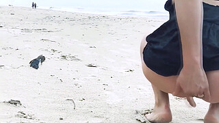 Filming an anal scene on the beach in front of passersby
