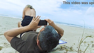 Filming an anal scene on the beach in front of passersby