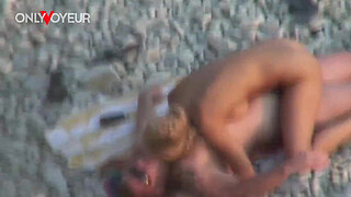 Beach Voyeur. Gorgeous blonde babe riding her man on a public beach