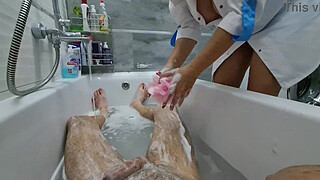 Stepmom cme in to wash her naked stepson, she ignores his big dick, he is very excited and wants to jerk off, she flashes her big tits and starts masturbating