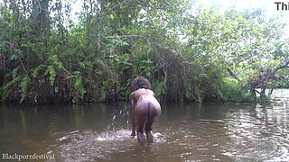 Attractive African village girl bathing in the river