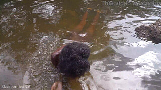 Attractive African village girl bathing in the river