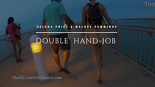 Double handjob on public beach