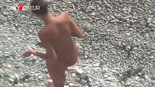 Beach Voyeur. Hot babe posing at the beach totally naked and with buttplug in her ass