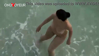 Busty amateur nudist swimming naked and getting her pussy licked and fucked on a public beach