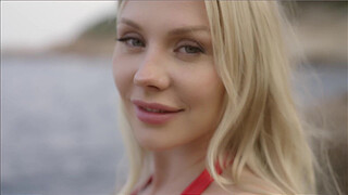 Horny blonde fucks the lifeguard on the beach behind the rocks