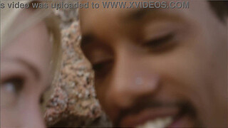 Horny blonde fucks the lifeguard on the beach behind the rocks