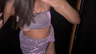 Young girl in mini skirt and sneakers at the swingers club.