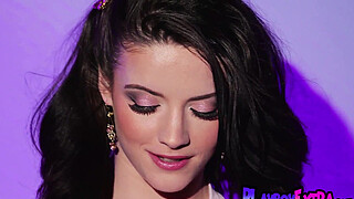 Bathing in a sultry violet glow big titted teen Lilly Redd posing naked