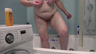 A bathroom camera watches a mature wife. A busty MILF shaves her legs. PAWG.
