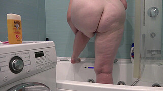 A bathroom camera watches a mature wife. A busty MILF shaves her legs. PAWG.