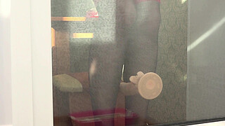 A neighbor watches through the window, as a MILF fucks herself with a dildo by the balcony door. Beautiful ass in doggy style.